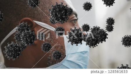 Image of covid 19 cells over man wearing face mask 128561633