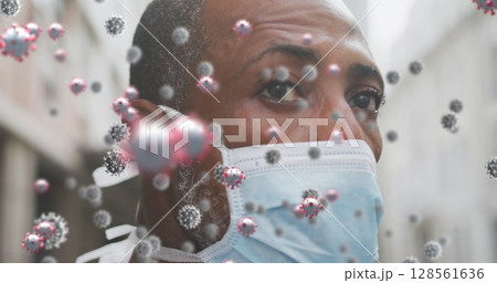 Image of covid 19 cells over man wearing face mask Image of covid 19 cells over man wearing face mask 128561636
