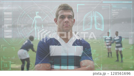 Rugby player standing confidently on field with digital health data overlay 128561696