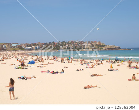 December 16, 2009. Sydney, Australia. Bondi Beach on a sunny day, bustling with sunbathers and swimmers enjoying the iconic sandy shores and clear blue waters. 128562004