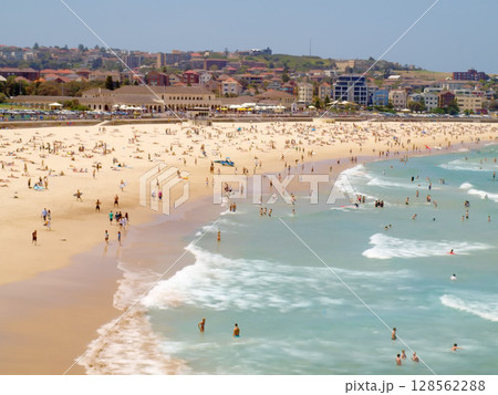 December 16, 2009. Sydney, Australia. Bondi Beach on a sunny day, bustling with sunbathers and swimmers enjoying the iconic sandy shores and clear blue waters. December 16, 2009. Sydney, Australia. Bondi Beach on a sunny day, bustling with sunbathers and swimmers enjoying the iconic sandy shores and clear blue waters. 128562288