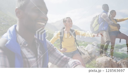 Composite of happy african american couple hiking on mountain, and stopping to admire the view Composite of happy african american couple hiking on mountain, and stopping to admire the view 128563697
