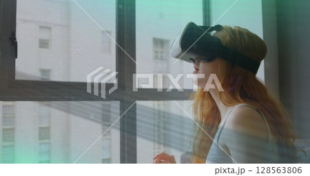 Image of scope scanning and data processing over woman wearing vr headset Image of scope scanning and data processing over woman wearing vr headset 128563806