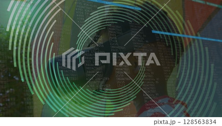 Image of spinning shapes over boy using vr headset Image of spinning shapes over boy using vr headset 128563834