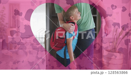 Image of hearts over happy caucasian father preparing son for school Image of hearts over happy caucasian father preparing son for school 128563866