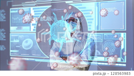 Image of covid cells over male doctor looking at screen with medical data processing Image of covid cells over male doctor looking at screen with medical data processing 128563983