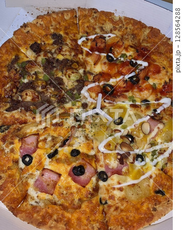 A delicious pizza with a golden crust, melted cheese, and savory toppings. Perfect for food-related designs, menus, or Italian-themed projects, capturing the essence of a classic comfort dish. 128564288