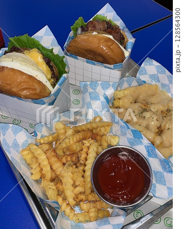 A classic combination of a juicy burger with fresh toppings served alongside golden, crispy French fries. Perfect for a satisfying meal that blends savory flavors and crunchy textures. 128564300