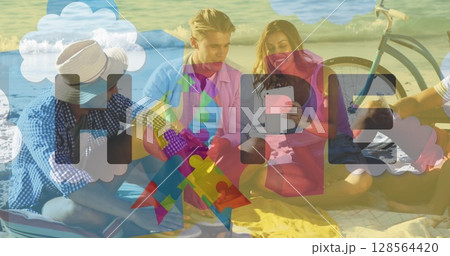 Image of colourful puzzle pieces and autism text over happy friends using tablet 128564420