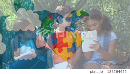 Image of colourful puzzle pieces heart over school children using tablets 128564455