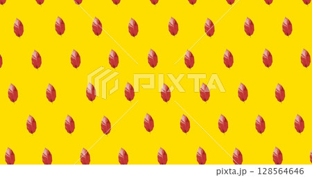 Image of multiple red autumn leaves over yellow background 128564646
