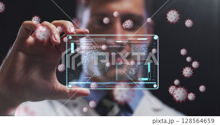 Image of covid cells over male doctor holding screen with medical data processing Image of covid cells over male doctor holding screen with medical data processing 128564659