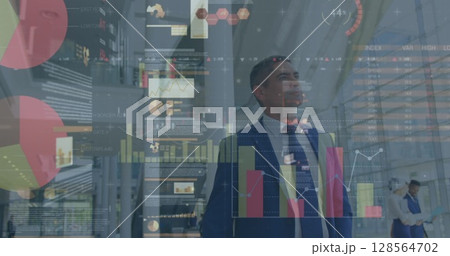 Image of financial data processing over diverse business people walking in modern office 128564702