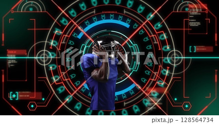 Image of african american male rugby player over scope scanning on black background 128564734