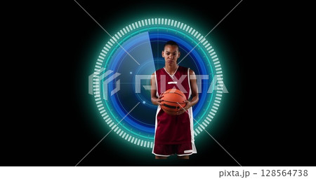 Image of african american female basketball player over scope scanning on black background 128564738