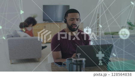 Image of network of connections over man using laptop Image of network of connections over man using laptop 128564838