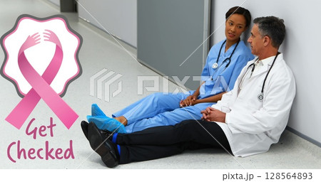 Image of breast cancer awareness text over diverse doctors at hospital Image of breast cancer awareness text over diverse doctors at hospital 128564893