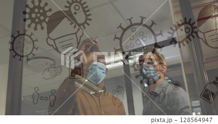 Image of covid 19 cells and icons floating over two men in face masks in office Image of covid 19 cells and icons floating over two men in face masks in office 128564947