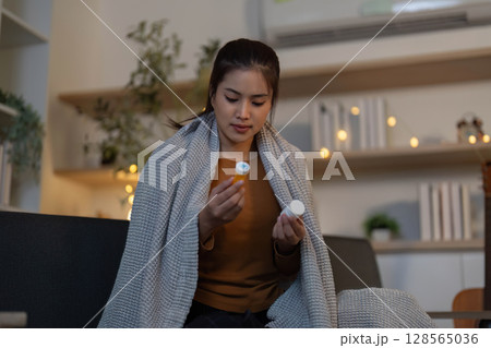 Medication Management. Young woman examining her medication at home. Medication Management. Young woman examining her medication at home. 128565036