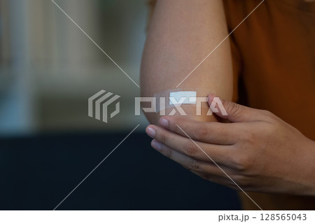 Health Awareness: Individual with Bandage on Elbow Injury 128565043