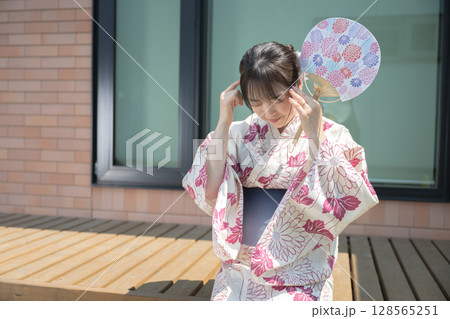 頭を抱える浴衣女性 128565251