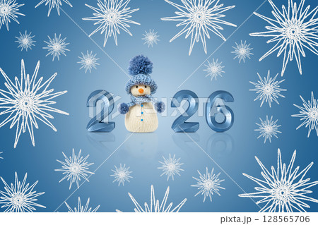 Christmas card of snowman, numbers 2026 and white snowflakes on a blue background. Winter fairy tale story with your own hands, hobby. Merry Christmas and New Year 2026 greeting card Christmas card of snowman, numbers 2026 and white snowflakes on a blue background. Winter fairy tale story with your own hands, hobby. Merry Christmas and New Year 2026 greeting card 128565706