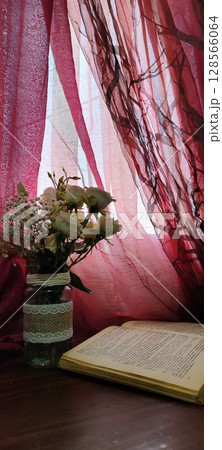 Still life of roses in vintage mason jar. Still life with book, coffee, and flowers. 128566064