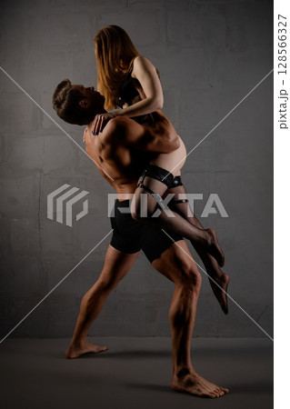 Couple in intimate pose showcasing beauty and allure in a stylish setting 128566327