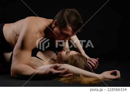 Couple embraces intimately in a sensual moment capturing beauty and desire 128566334