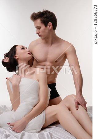 Romantic couple enjoying intimate moment in soft lighting setting 128566373
