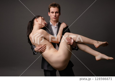 Couple poses together in an artistic display of intimacy and connection Couple poses together in an artistic display of intimacy and connection 128566871