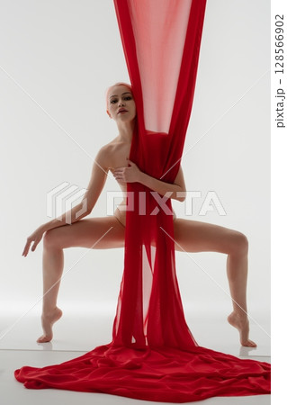 Creative expression of beauty with flowing fabric in a bright studio setting 128566902