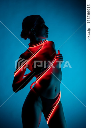 Silhouette of a radiant woman in a minimalist glow Silhouette of a radiant woman in a minimalist glow 128566918