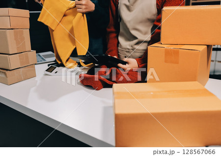 Portrait of Starting small businesses SME owners, two Asian woman check online orders Selling products working with boxs freelance work at home office, sme business online small medium enterprise 128567066