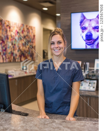 Vet Examines Dogs Eye With Tool in Warm Ambient Light During a Routine Checkup in a Cozy Clinic 128567608