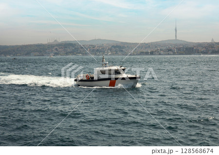 A patrol boat operates on the sea close to Istanbul's coastline 128568674