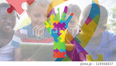 Image of colourful puzzle pieces ribbon and hand over children Image of colourful puzzle pieces ribbon and hand over children 128568837