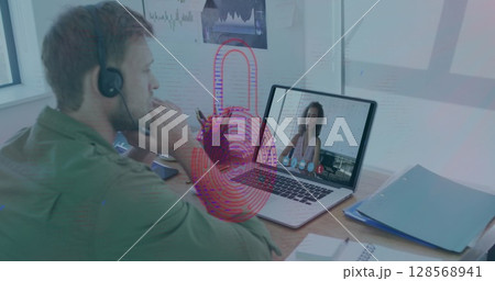 Image of biometric fingerprint over caucasian man using phone headset and laptop 128568941