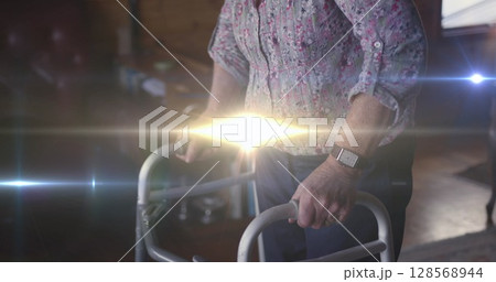 Image of light moving over midsection of senior woman using walking frame Image of light moving over midsection of senior woman using walking frame 128568944