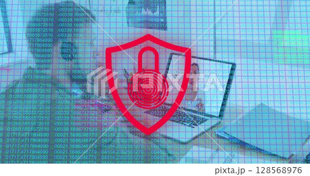 Image of biometric fingerprint with shield over caucasian man using phone headset and laptop 128568976