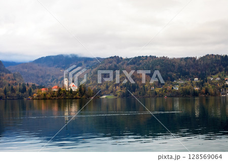 Autumn landscape with lake Bled in Slovenia. St Mary church in island 128569064