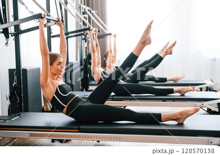 Women in fitness center are doing exercises Women in fitness center are doing exercises 128570138
