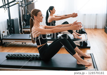 Using device with circles for the spine. Women in fitness center are doing exercises 128570181