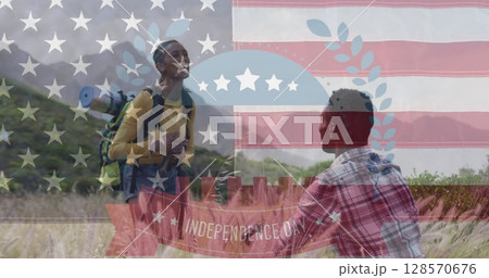 Image of independence day text over smiling diverse couple high fiving and hiking 128570676