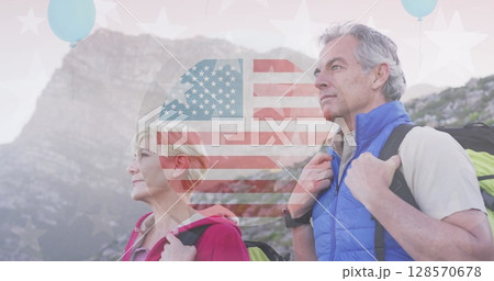 Image of american flag over senior caucasian couple hiking in mountains 128570678