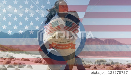 Image of independence day text over smiling diverse couple carrying in mountains 128570727