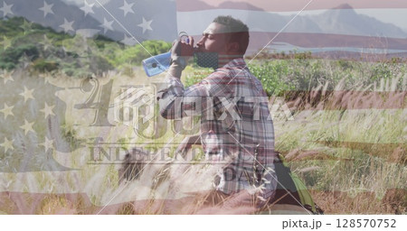 Image of flag of united states of america and fourth of july text over man drinking water 128570752