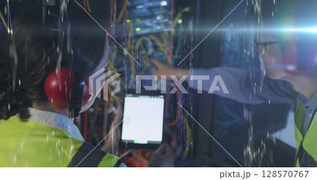 Image of data over diverse male and female it engineers checking computer server Image of data over diverse male and female it engineers checking computer server 128570767