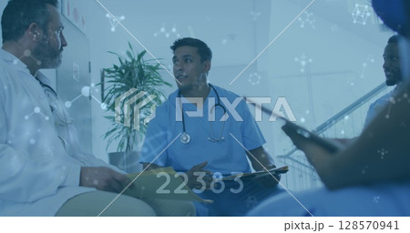Image of numbers changing and molecules over male doctors 128570941