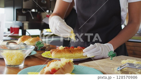 Image of broccoli over female food vendor preparing food for customer 128570986